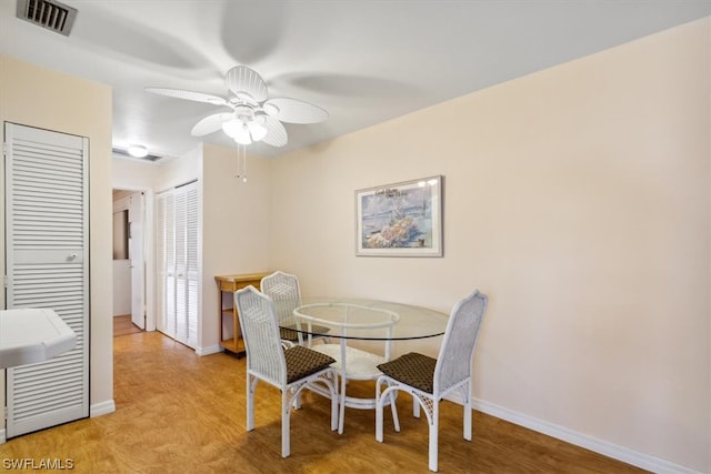 dining space with ceiling fan and light hardwood / wood-style floors