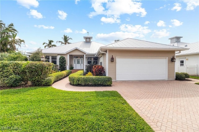 single story home with a garage and a front yard