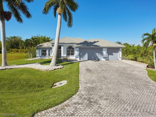 ranch-style home with a front lawn and a garage