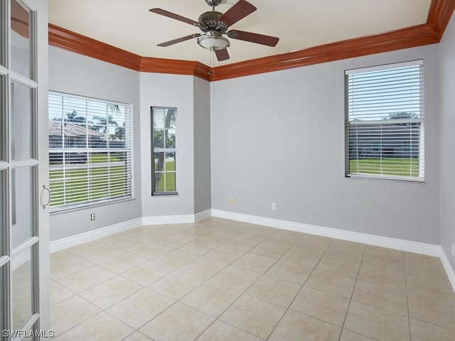 empty room with light tile flooring, ornamental molding, ceiling fan, and a wealth of natural light