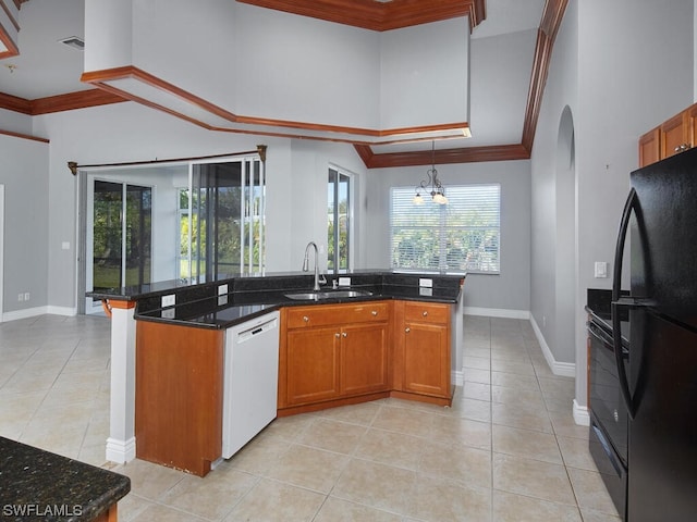 kitchen featuring sink, a chandelier, white dishwasher, light tile flooring, and black fridge