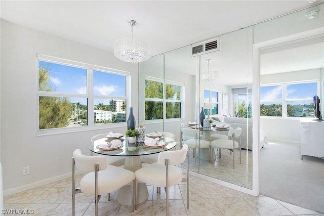 dining area featuring baseboards, marble finish floor, visible vents, and an inviting chandelier