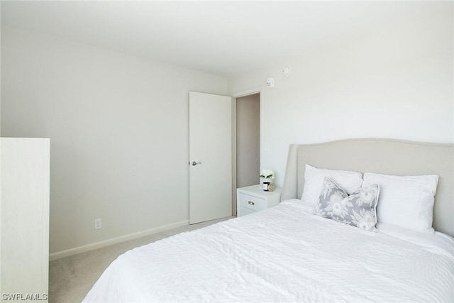 bedroom with carpet flooring and baseboards