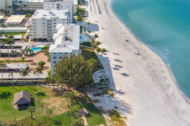 bird's eye view with a water view and a beach view