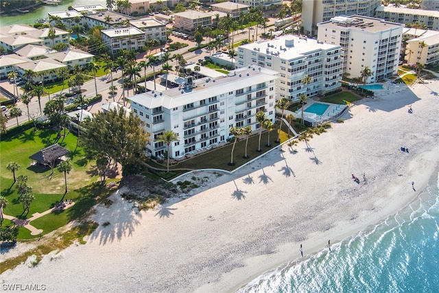 birds eye view of property with a view of the beach, a water view, and a view of city