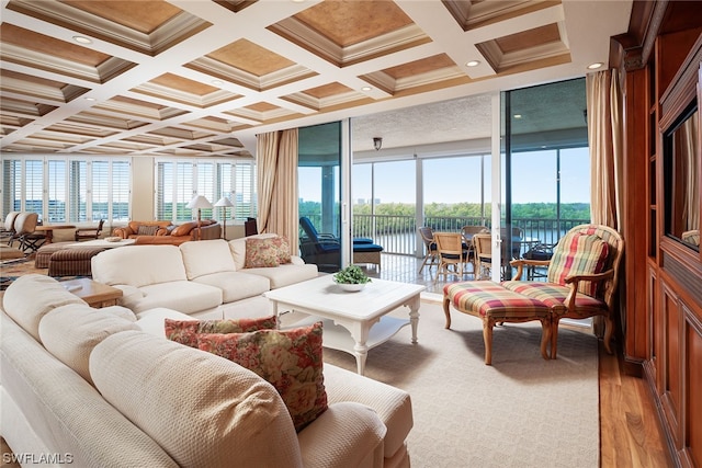 living room with crown molding, hardwood / wood-style floors, coffered ceiling, a water view, and beam ceiling