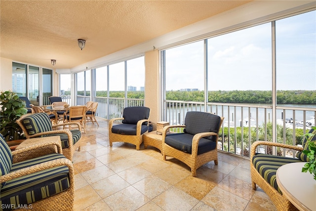 sunroom / solarium with a water view