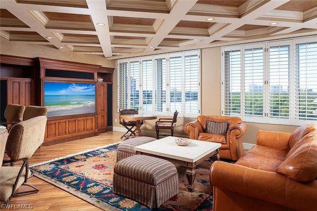 living room featuring beamed ceiling, coffered ceiling, plenty of natural light, and light wood-type flooring