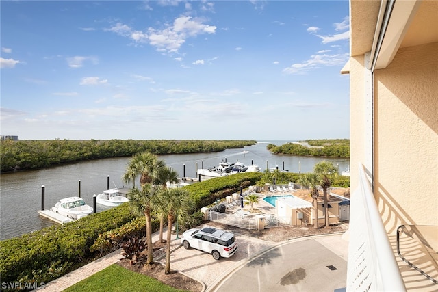 exterior space featuring a dock and a water view