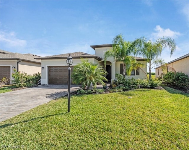 view of front of home with a front lawn and a garage