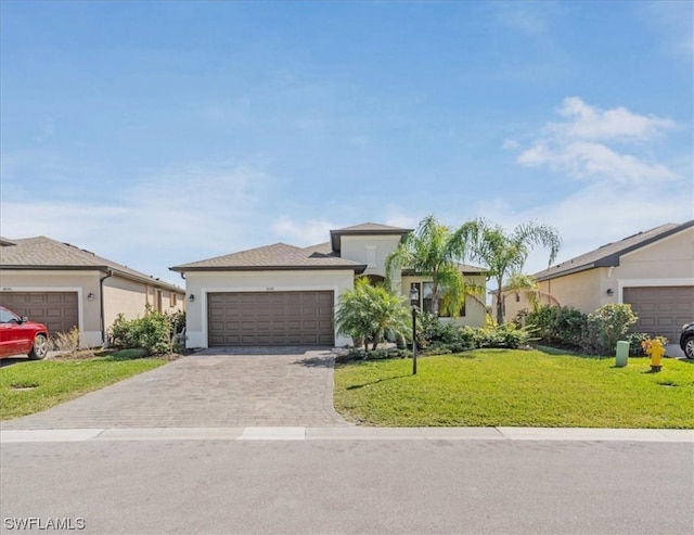 single story home featuring a front lawn and a garage