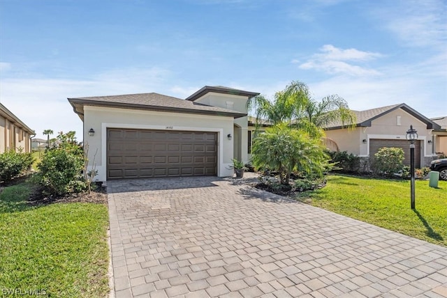 view of front of home with a front yard and a garage