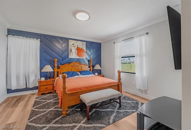 bedroom featuring ornamental molding and light wood-type flooring