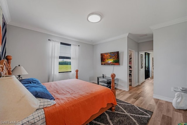 bedroom featuring light hardwood / wood-style flooring and crown molding