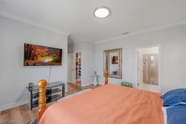 bedroom with ensuite bathroom, light hardwood / wood-style floors, and crown molding