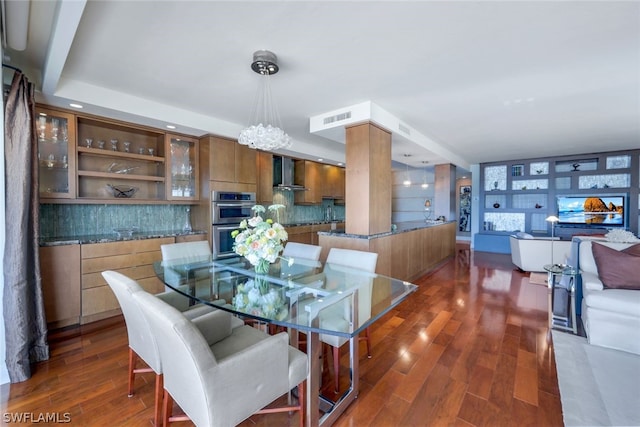 dining area featuring a notable chandelier and dark hardwood / wood-style floors