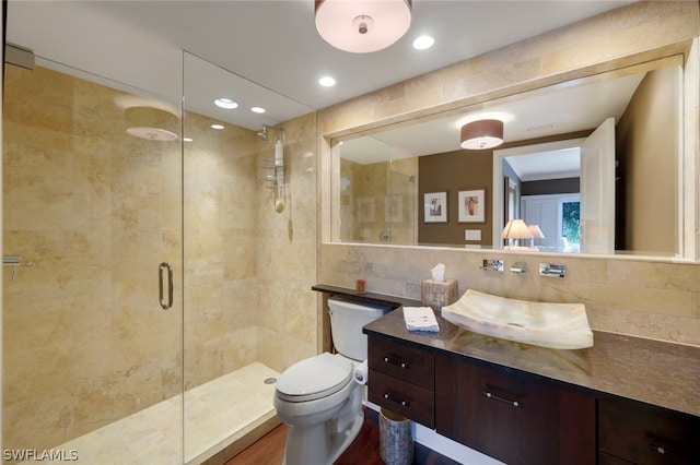 bathroom with tile walls, an enclosed shower, wood-type flooring, and vanity