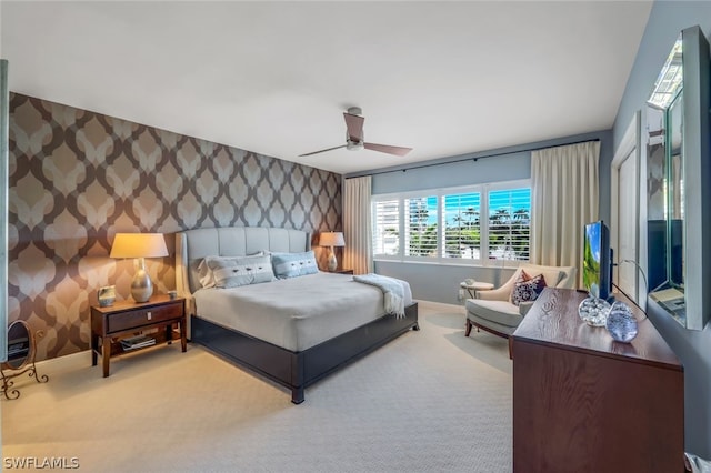 bedroom featuring ceiling fan and carpet