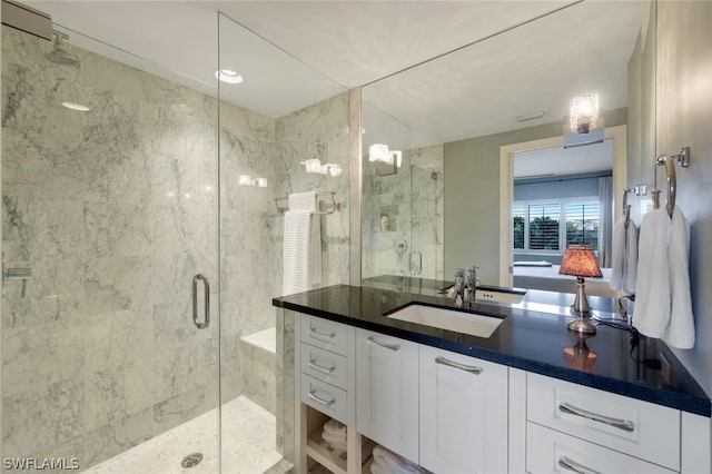 bathroom with walk in shower and vanity