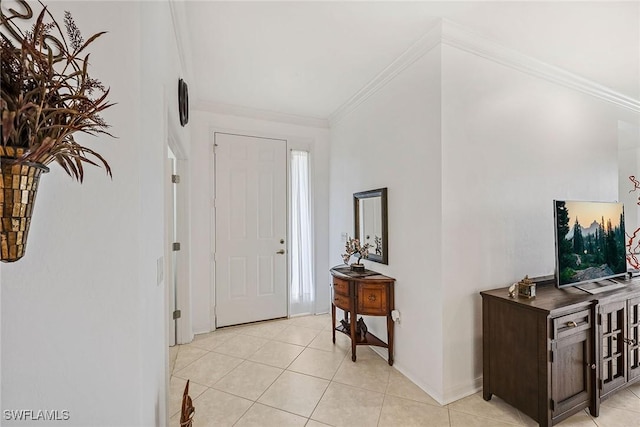 tiled foyer entrance featuring ornamental molding