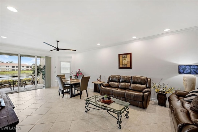 living room with light tile patterned floors, ceiling fan, and ornamental molding