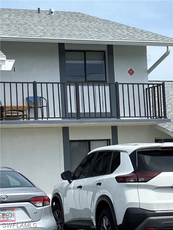 view of side of home featuring a balcony