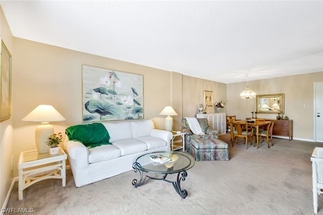 carpeted living room with a notable chandelier