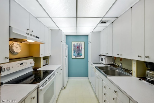 kitchen featuring sink, white cabinets, a paneled ceiling, and white appliances