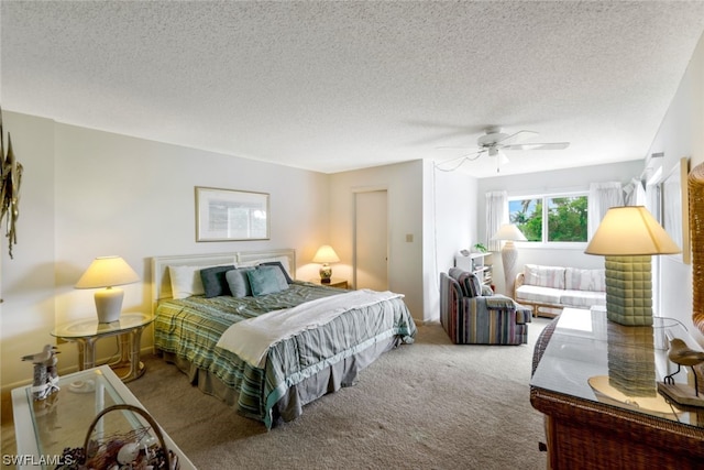 carpeted bedroom with a textured ceiling and ceiling fan