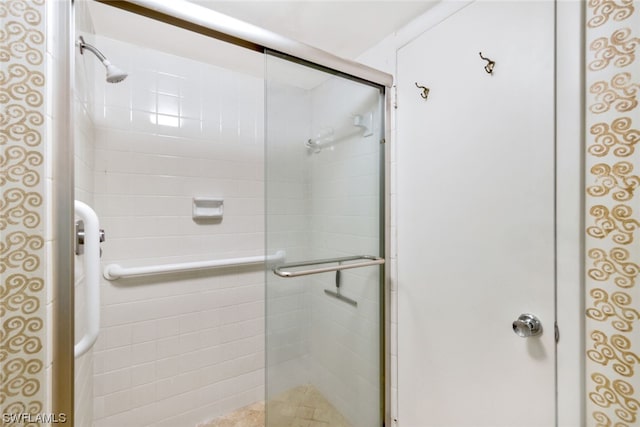 bathroom with a shower with shower door