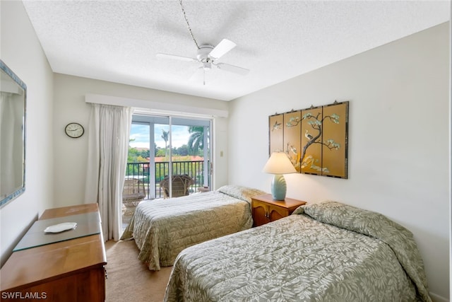 carpeted bedroom with a textured ceiling, access to exterior, and ceiling fan