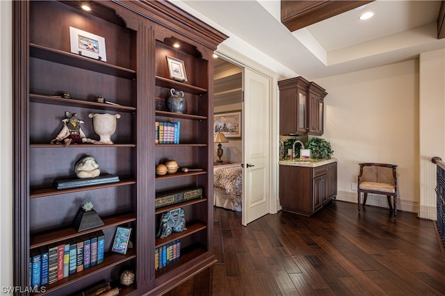 interior space with dark wood-type flooring and beamed ceiling