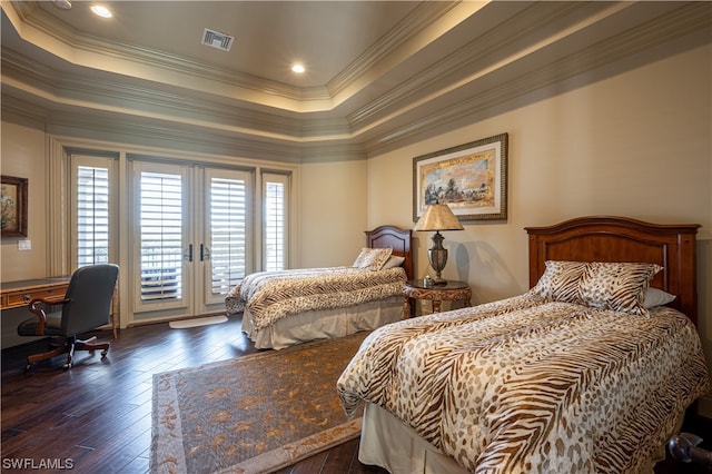 bedroom with access to outside, a tray ceiling, french doors, and dark hardwood / wood-style flooring