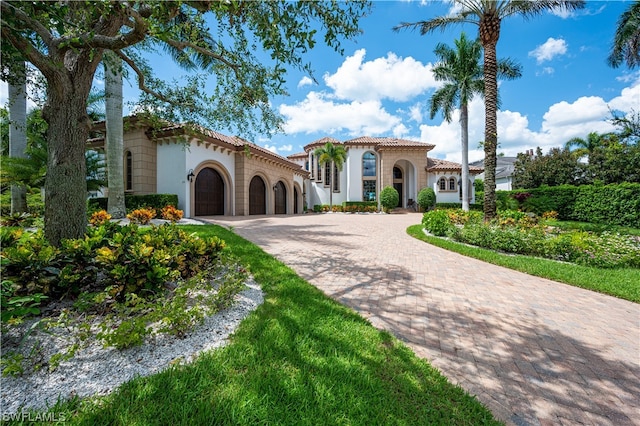 mediterranean / spanish-style home with a garage