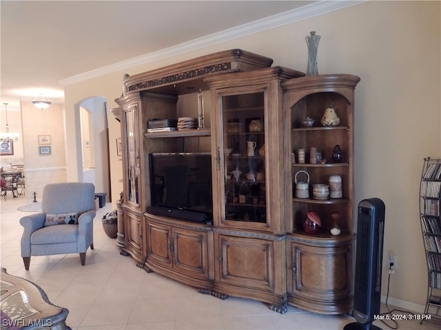 living room with light tile flooring and ornamental molding