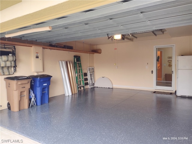 garage featuring a garage door opener and white fridge