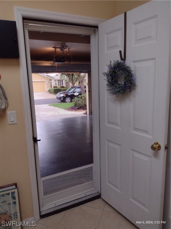 doorway to outside featuring light tile floors