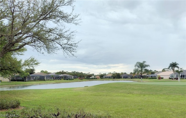 view of nearby features with a lawn and a water view