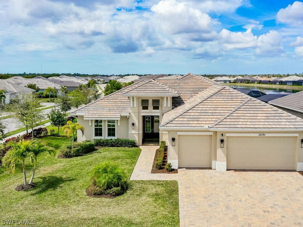 view of front of home with a front yard and a garage