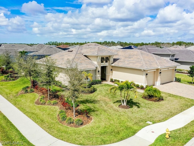 view of front of house featuring a front lawn and a garage