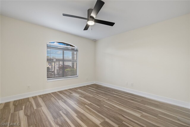 spare room with ceiling fan and light hardwood / wood-style flooring