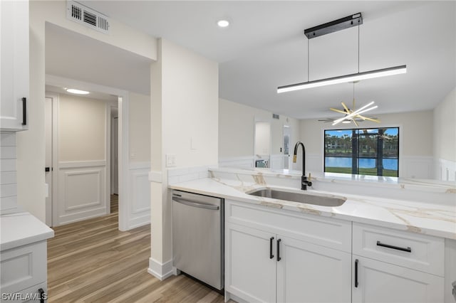 kitchen featuring white cabinets, stainless steel dishwasher, and sink