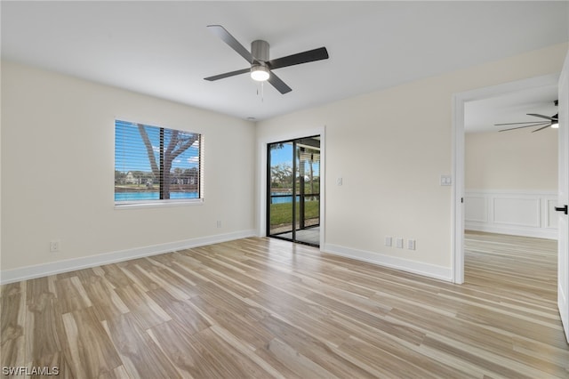 unfurnished room featuring light hardwood / wood-style floors and ceiling fan