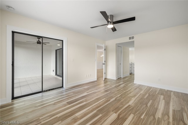 unfurnished bedroom with a closet, ceiling fan, and light wood-type flooring