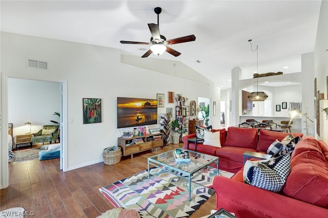 living room featuring vaulted ceiling, ceiling fan, and dark wood-type flooring