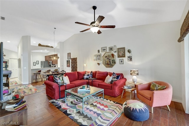 living room featuring lofted ceiling, ceiling fan, and dark hardwood / wood-style flooring