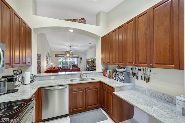 kitchen featuring stainless steel dishwasher, light stone counters, decorative light fixtures, and sink