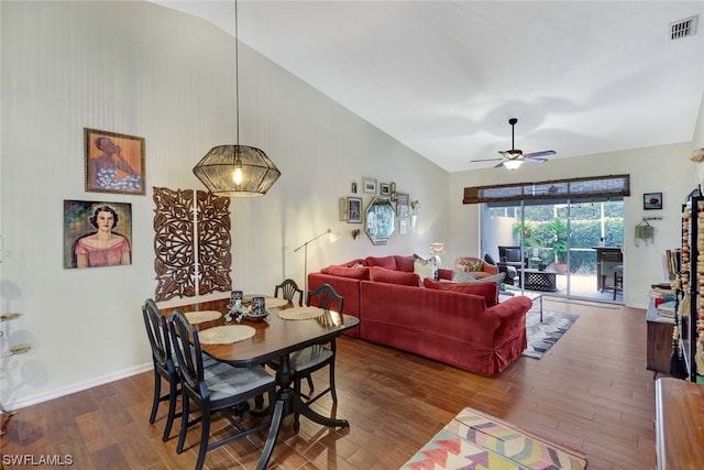 dining space with dark wood-type flooring, vaulted ceiling, and ceiling fan