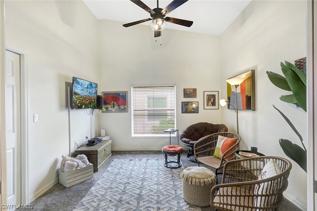 sitting room featuring light colored carpet, ceiling fan, and high vaulted ceiling