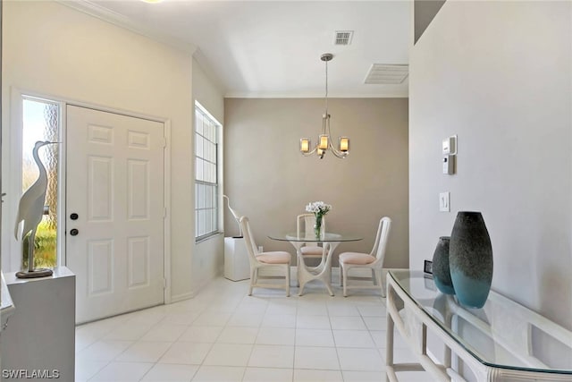 tiled dining area with an inviting chandelier, plenty of natural light, and ornamental molding